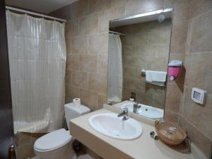 a bathroom with a sink and a toilet and a mirror at Holy Land Hotel in Bethlehem +27 photos