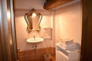 a bathroom with a sink and a mirror on the wall at Farmhouse Il Santo in Greve in Chianti +49 photos