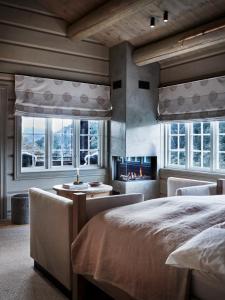 a bedroom with two beds and a fireplace at Storfjord Hotel in Skodje