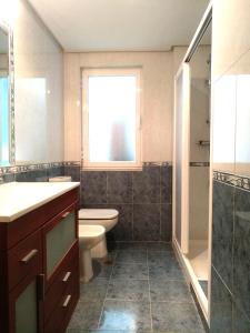 a bathroom with a sink and a toilet and a window at www Parques de la Catedral travel com Parking privado Gratis in León +9 photos