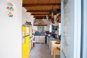 a kitchen with a yellow refrigerator and a counter at Casa Elisa Lipari in Lipari +38 photos