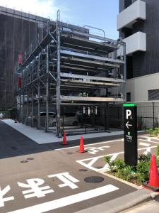 a parking lot with orange cones in front of a building at Tmark City Hotel Tokyo Omori in Tokyo