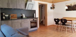a kitchen with a couch and a table and chairs at Ferienwohnung Bader in Bolsterlang