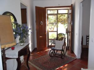 a living room with a chair and a piano at Mas Cabrit in Les Franqueses del Vallès +20 photos