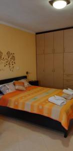 a bedroom with a large bed with towels on it at Βlue Horizon Lixouri in Lixouri
