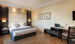 Voodi või voodid majutusasutuse Ambassador Hotel toas