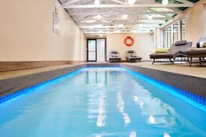 a swimming pool with blue water in a building at First Group Riviera Suites in Cape Town