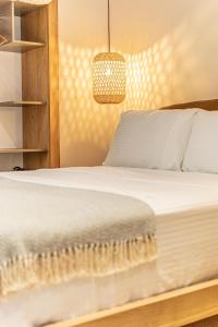 a bedroom with a bed and a chandelier at F & S LOUNGE SUITES in Parga