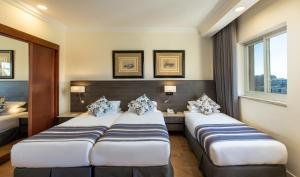 Voodi või voodid majutusasutuse Ambassador Hotel toas