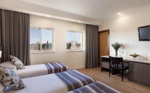 Voodi või voodid majutusasutuse Ambassador Hotel toas