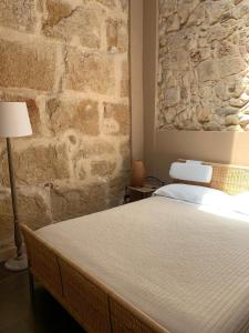 A bed or beds in a room at Chiusa Di Carlo Agriturismo