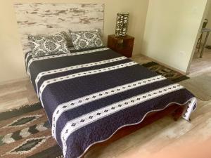 a large bed with a black and white blanket at Villa Füred in Balatonalmádi +7 photos