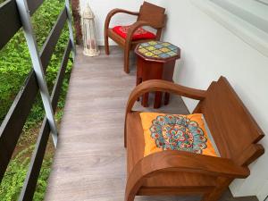 a stairway with two chairs and a bench at Villa Füred in Balatonalmádi
