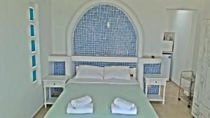 a bedroom with a bed with two towels on it at Antoninis Village in Houlakia