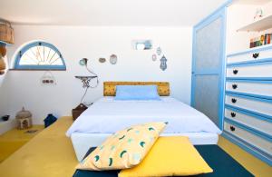 a bedroom with a bed and a dresser at Casa Elisa Lipari in Lipari