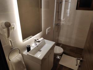 a bathroom with a sink and a toilet and a mirror at Accommodation Plitvice in Korenica +69 photos