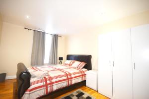 a bedroom with a bed and a large window at London Zone 2 Three Bedroom Apartment in London