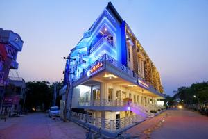 a building with blue lights on the side of it at Hotel Swagath Grand Miryalaguda in Miriālgūda