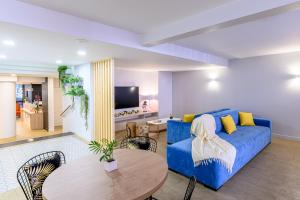 a living room with a blue couch and a table at Citadines Wilson Toulouse in Toulouse