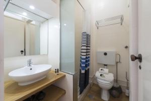 a bathroom with a sink and a toilet at BmyGuest - Santa Catarina's Loft in Porto