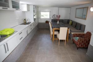 a kitchen with a table and a dining room at Villa Liberte in Blagaj