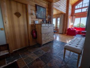 a living room with a dresser and a red couch at Villa Lohusalo I with Sauna in Lohusalu