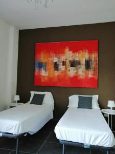 duas camas num quarto com um quadro na parede em B&b My Bergamo em Bérgamo
