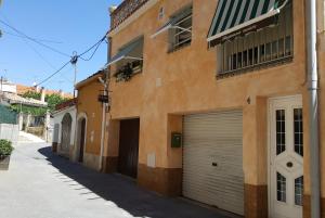 a building with two garage doors on a street at Apartament Torrellenc in Torrellas de Foix
