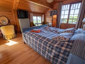 a bedroom with a bed in a wooden cabin at Villa Lohusalo I with Sauna in Lohusalu