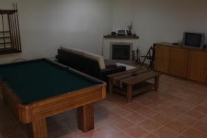 a living room with a pool table and a couch at Cantinho do Bouço Velho in Couto de Baixo