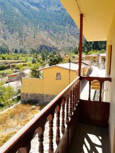 a balcony of a house with a view of a mountain at Casa Patacalle in Ollantaytambo