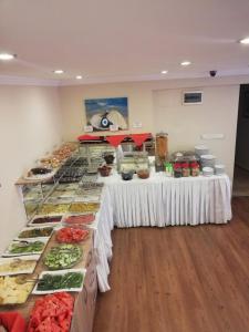 a buffet line with many different types of food at Hotel Crowded House in Eceabat