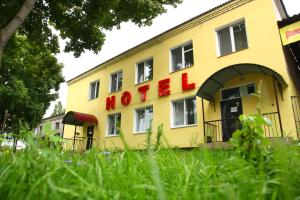 a yellow building with a hotel sign on it at Hotel Miks in Chernihiv