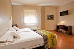 Postel nebo postele na pokoji v ubytování Hotel Fuente El Cura