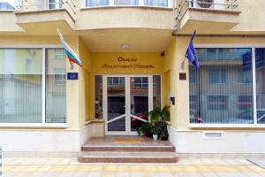 a building with flags in front of a building at CityResidence Aparthotel in Sofia