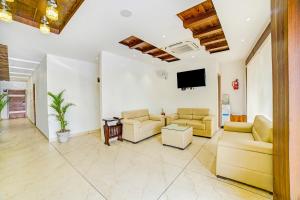 a living room with couches and a flat screen tv at Hotel Destination in Chandīgarh