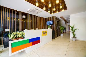 a brightly colored lobby with a colorful counter and plants at Hotel Destination in Chandīgarh