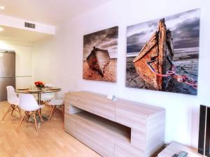 una sala de estar con 3 pinturas en la pared en Apartment Escorxador by Interhome, en Colera