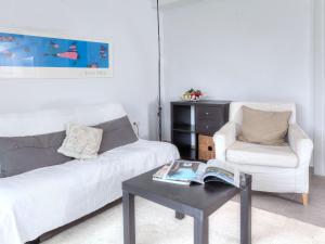 a living room with a white couch and a coffee table at Apartment Matthias-2 by Interhome in Llança