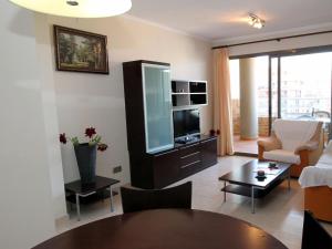 a living room with a couch and a tv and a table at Apartment Torre Maestral-1 by Interhome in Cala de Finestrat