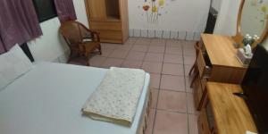Llit o llits en una habitació de Sun Wu Homestay