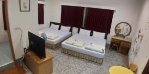 Llit o llits en una habitació de Sun Wu Homestay