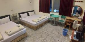 Llit o llits en una habitació de Sun Wu Homestay