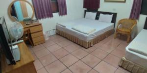 Llit o llits en una habitació de Sun Wu Homestay