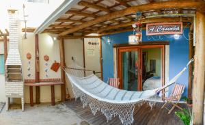 a hammock hanging outside of a store at a casinha in Serra Grande
