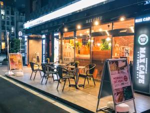 a table and chairs outside of a restaurant at night at HOTEL LiVEMAX Umeda WEST in Osaka