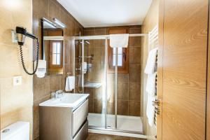 a bathroom with a shower and a sink at Complejo Hotelero La Braña in San Isidro +35 photos