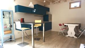 a kitchen with blue cabinets and a table and chairs at INTERNO 2 Este centro in Este