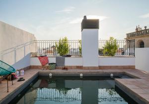 a swimming pool in the middle of a patio at Feria Pool & Luxury in Seville