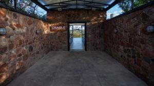 an entrance to a brick building with a sign that reads garage at Cradle Boutique Hotel in Lanseria